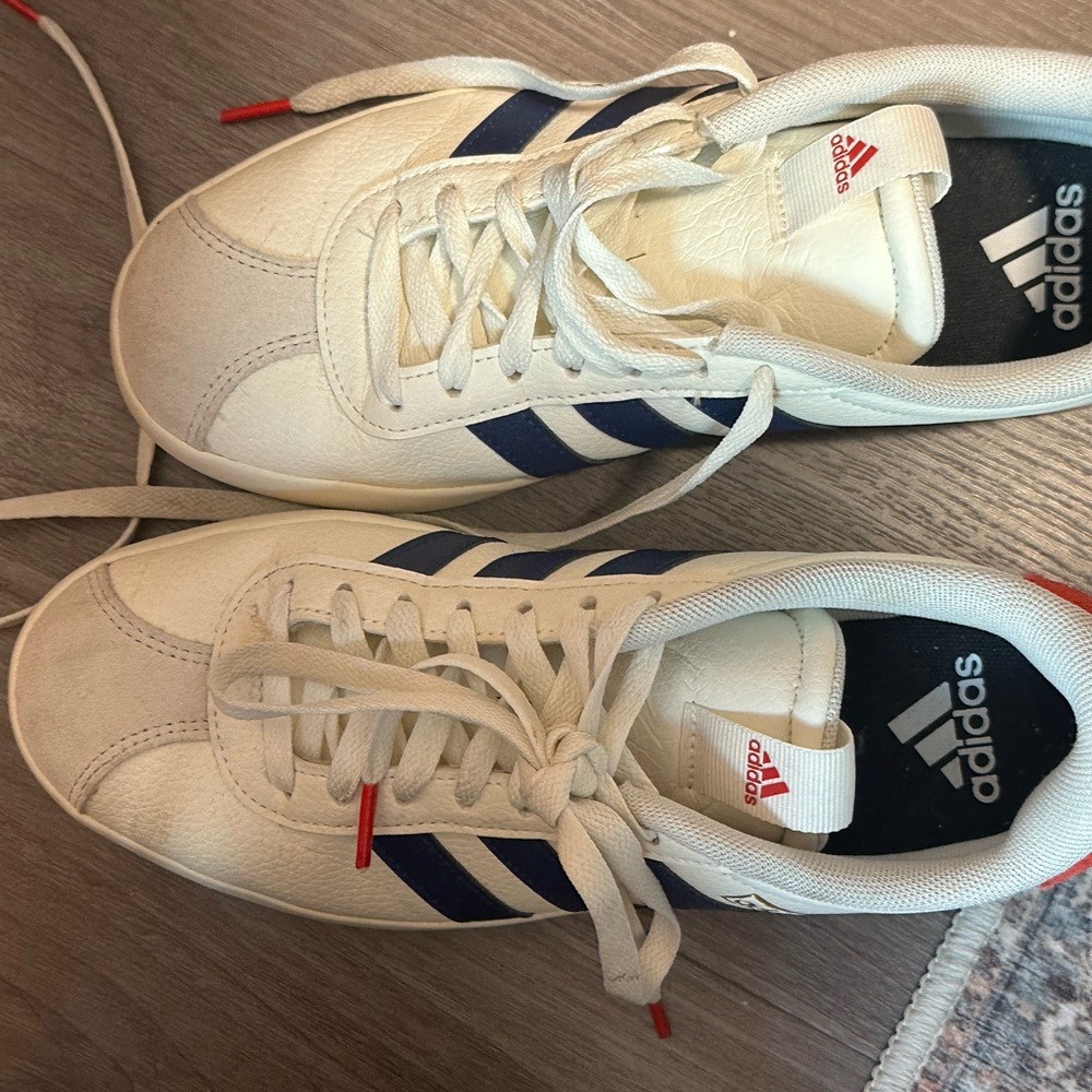 White adidas with blue stripes and red details